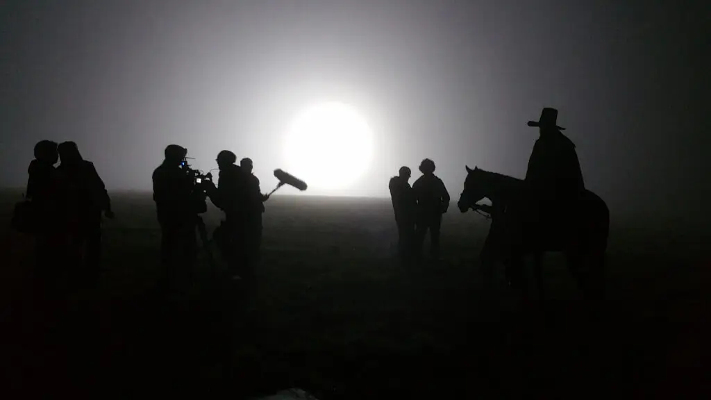 Arri 12kW HMI backlighting mist, cast and crew silhouetted