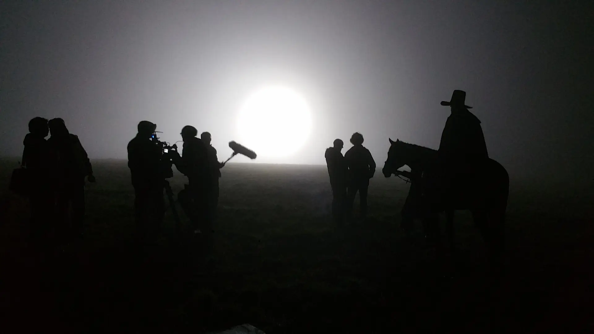 Arri 12kW HMI backlighting mist, cast and crew silhouetted